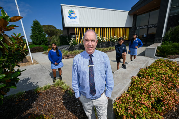 Wellington Secondary College principal Hugh Blaikie with year 7 students (left to right) Saanvi Vijay, Jordan Masip and Lisara Hewage.