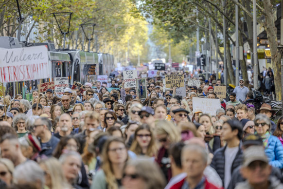 Protesters rally in the Melbourne CBD against gender-based violence.
