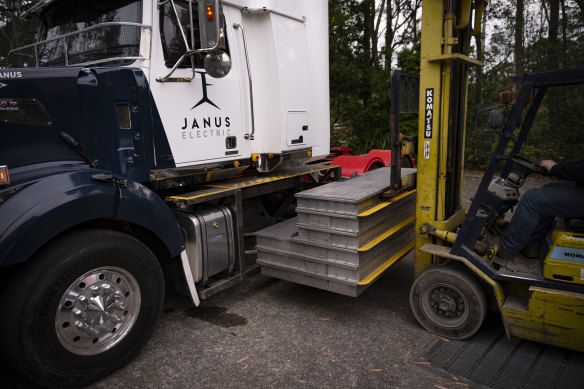 A fully electric truck being loaded with  a battery.