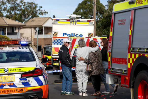 Neighbours look at the ongoing rescue effort at Waikanda Crescent in Whalan after the explosion.