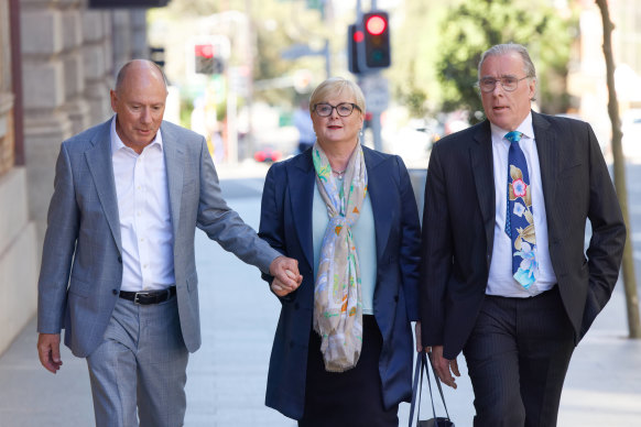 Former Minister Linda Reynolds arrives at the Perth Supreme Court for a mediation session with Brittany Higgins, flanked by husband Robert Reid (left) and lawyer Martin Bennett.