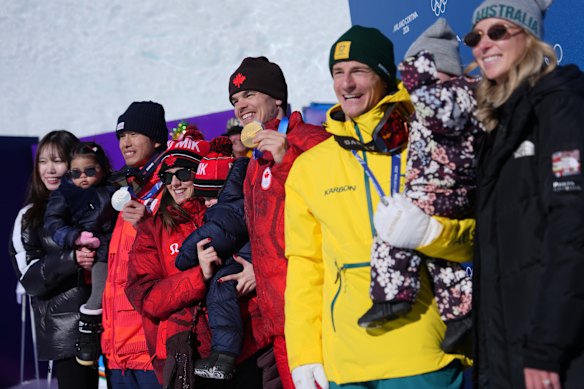 Dual moguls medallists Ikuma Horishima, Mikael Kingsbury and Matt Graham with their partners and kids.