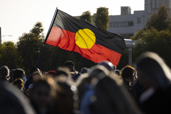 An Aboriginal flag flying at the candlelight vigil for Cassius Turvey.