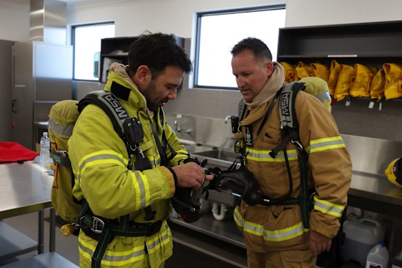 David Maxwell (right) helping Benjamin Preiss into the breathing apparatus. 