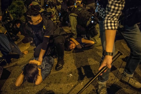 Police detain protesters attempting to escape from a police siege on the Poyltech University campus in Hong Kong this week.