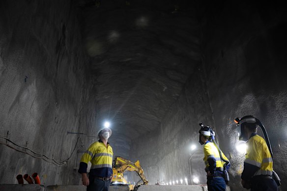 Construction workers in one of the giant vent chambers for the Western Harbour Tunnel.