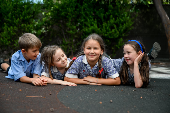 Leza Solovei (centre) fled Ukraine last April and has been welcomed by students at Sacred Heart Primary School in Kew.