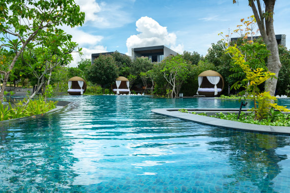 Hotel pool and villas surrounding it.