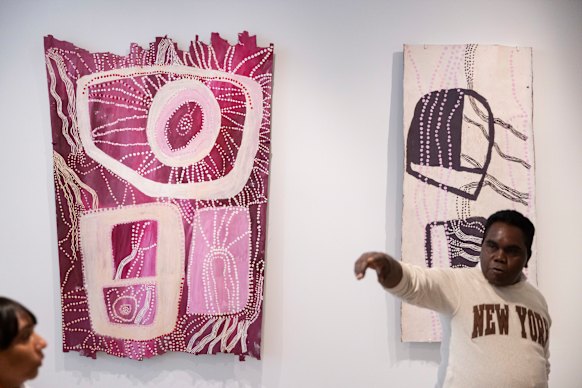 Yinimala Gumana from Yirrkala, north-east Arnhem Land, with the two works by Yolŋu artist Nonggirrnga Marawili.