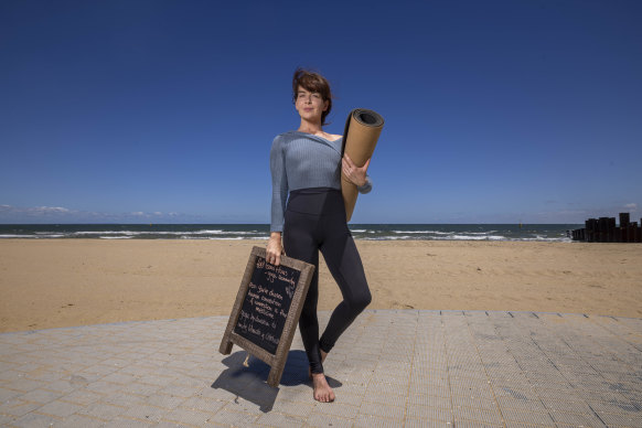 Eliza Hilmer may be forced to stop her yoga by donation classes on St Kilda beach after the council intervened. 