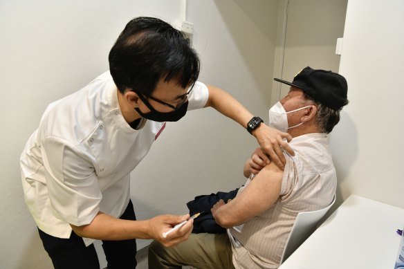 Chieu Lim, 81, receives a vaccine at Cabramatta in Sydney’s west.