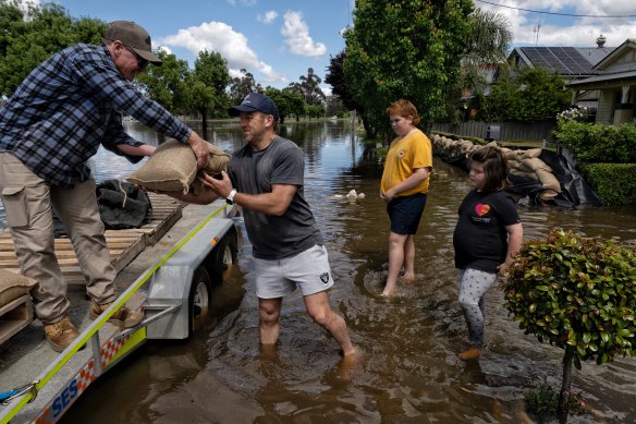 Forbes resident Justin Walker helps sandbag a friend’s home in the “calm before the storm”. 