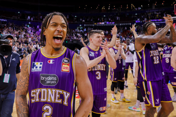 Jaylen Adams celebrates with Kings teammates.