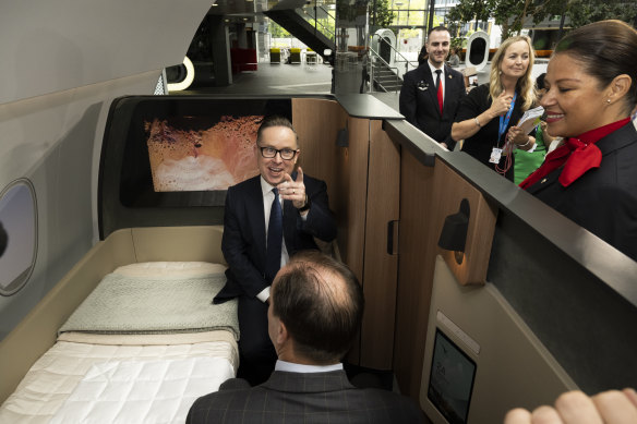 Qantas chief executive Alan Joyce unveiling a new cabin after the results announcement.