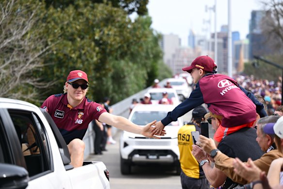 Brisbane’s Levi Ashcroft lays some skin on a young fan.