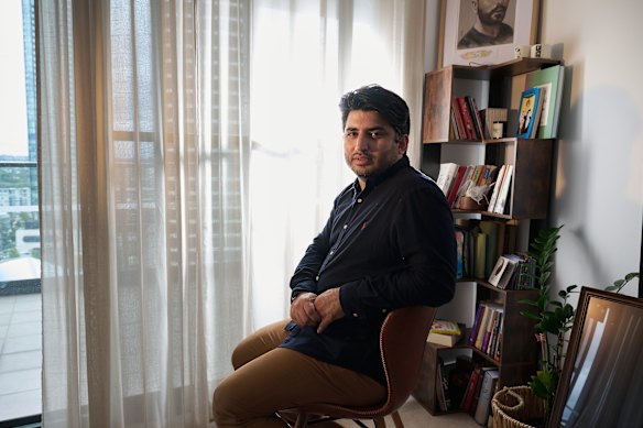 Mohammad Hashemi, an Iranian in the diaspora, behind him, a picture of his cousin who died at the hands of the Iranian regime following protests two years ago.