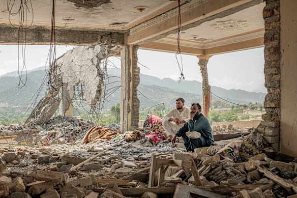 People at the remains of a house that was targeted during Pakistani airstrikes in June, at Mandakhel village, Paktia Province near the border with Pakistan, in Afghanistan.