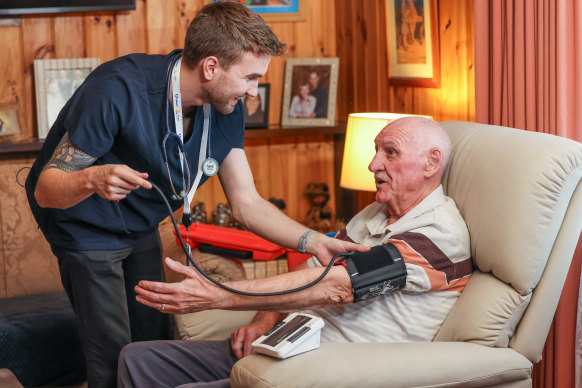 My Home Hospital nurse Elijah Shevchenko checks on pneumonia patient Leonard Nicholls.