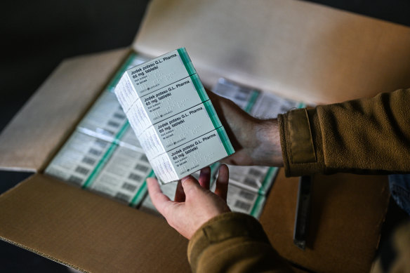 Fears for the region: a firefighter opens a box full of Iodine tablets in Poland. 