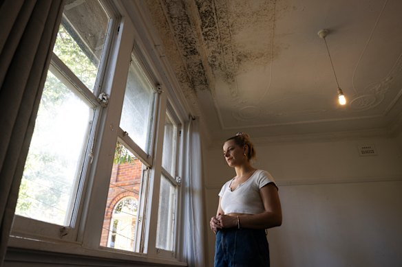 Holly Konopka in her rented Coogee apartment with mould and mushrooms growing on the ceiling.