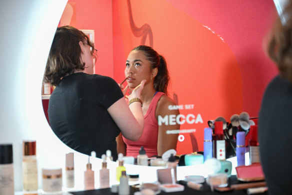 Australian player Lizette Cabrera gets her make-up done by a MECCA make-up artist at the beauty bar for players. 