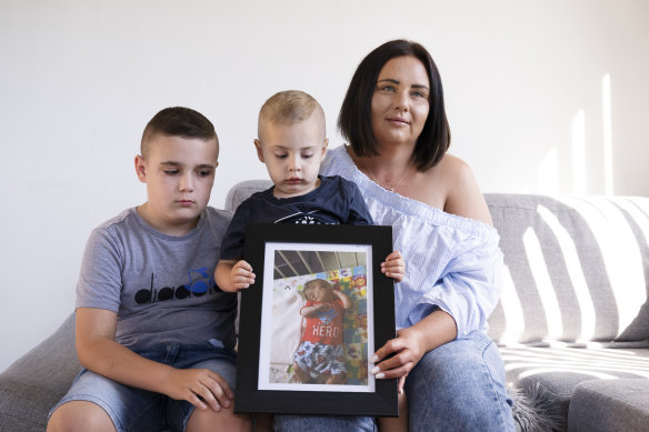 Elizabeth Miroforidis with her sons Romeo and Alex Kakias holding a photo of their brother Elias at their Peakhurst home.