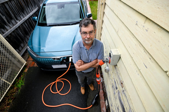 Policy consultant Bryce Gaton charging his electric vehicle. 