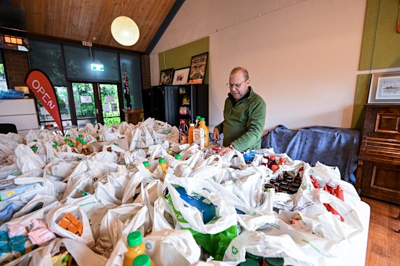 Reverend Andrew Smith with donated goods he will distribute to people in Kalorama. 