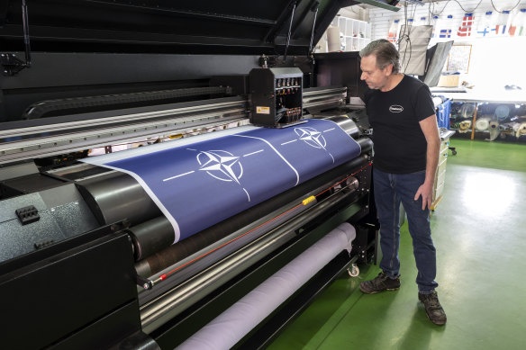CEO of flag manufacturer Flagghuset Stig Kvarnryd watches as new NATO flags are printed in Akersberga, outside Stockholm, Sweden, on Thursday.