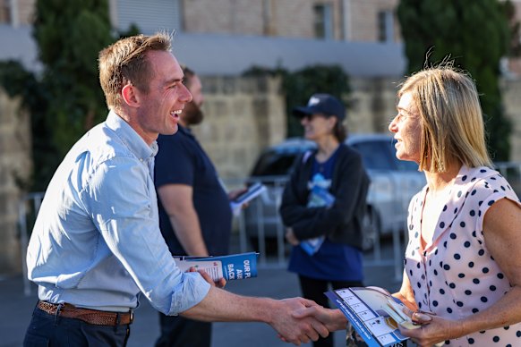 Liberal candidate for Curtin Tom White meeting candidates at the Claremont polling booth on Wednesday.