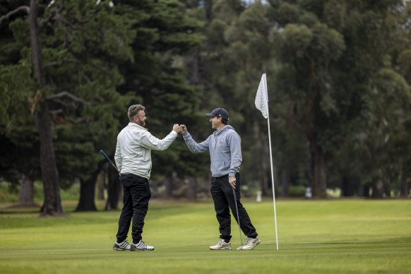David McCartney [left] and Dene Heath were among those who hit Albert Park Golf Course on Wednesday morning. 