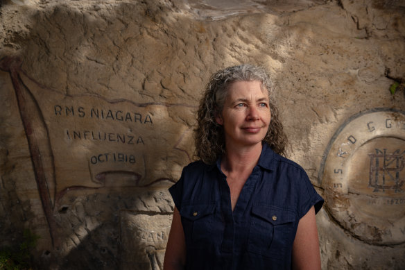 Q Station interpretation manager Helen Drew with an inscription marking the first ship to be quarantined with Spanish Influenza.