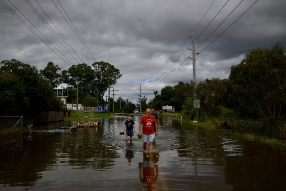 Residents wade through what used to be a road.