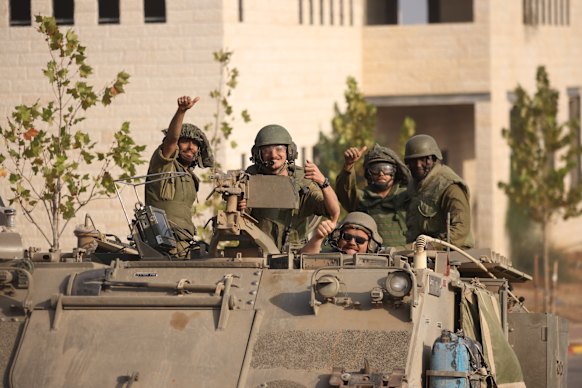  Israeli tanks and troops move near the border with Gaza on October 28, 2023 in Sderot, Israel.