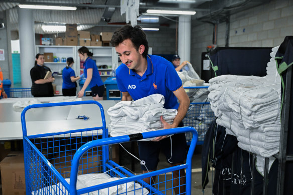 Jacob Naqash prepares to return towels to the player facilities. 