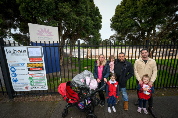 Kingswood Primary School parents Taryn and Mike Lapa (left) with baby Zoe, Evie and Mia (front); and Daniel Macpherson with daughter Arabella, outside the school.