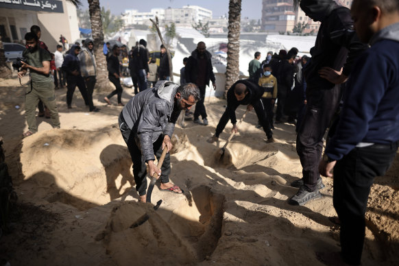 Palestinians dig graves in Nasser Hospital in Khan Yunis to bury their relatives who were martyred in the Israeli bombing.