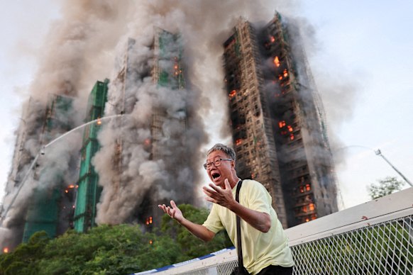 A man, who said his wife was trapped inside one of the buildings, is pictured amid the catastrophe.