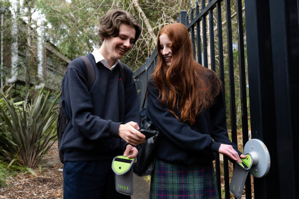 Davidson High School year 10 students Daniel Kenny and Annika Hore with the pouches used by the school to limit phone usage during school hours.