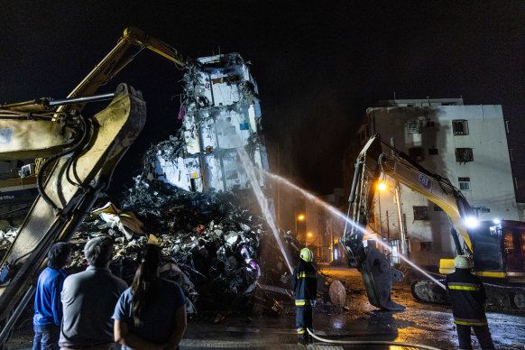 Rescue teams demolish a building in Hualien that collapsed following Wednesday’s earthquake.