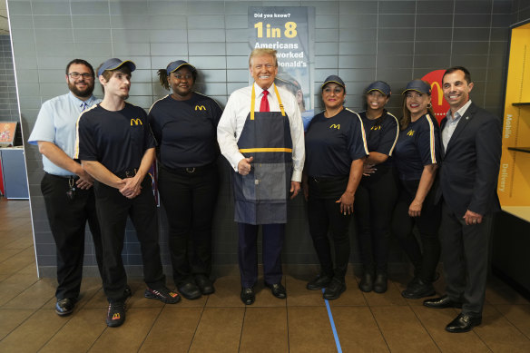  Donald Trump poses with employees during a visit to McDonald’s.