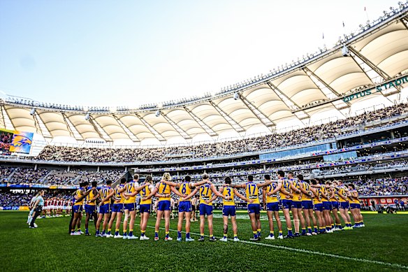 The Eagles players arm in arm before their match against St Kilda.