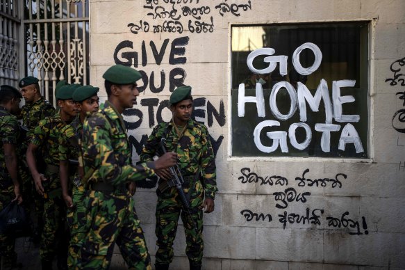 Sri Lankan soldiers patrol near the official residence of president Gotabaya Rajapaksa.