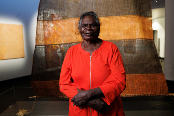 Margaret Rarru Garrawurra, in front of her NATSIAA main prize winner, Dhomala (pandanus sail), 2022.