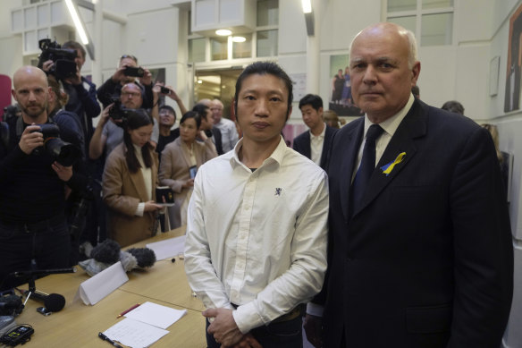 Hong Kong protester Bob Chan, left, who alleged he was dragged into the Chinese Consulate in Manchester and beaten up during a demonstration, poses with British MP Iain Duncan Smith in London.