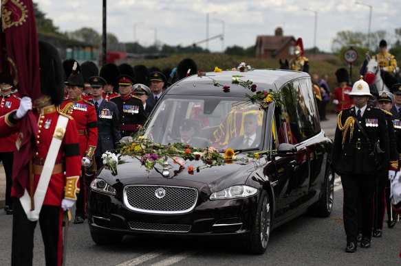 The Queen’s hearse covered in flowers as it arrives in Windsor.
