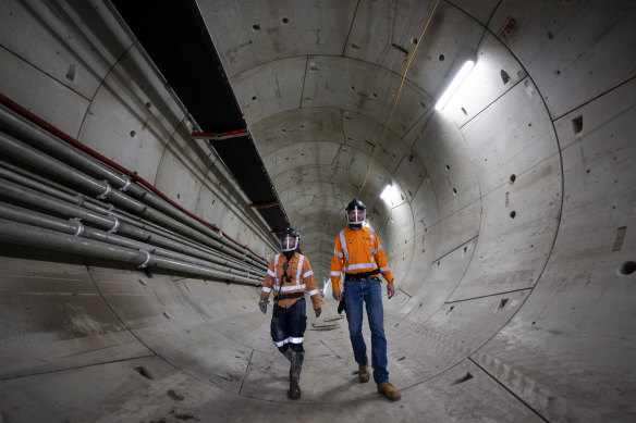 Workers in one of the rail tunnels at the site of the airport station.