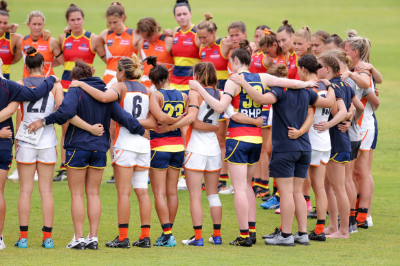 Players from both sides pause to remember former Giant Jacinda Barclay during a pre-season match between the Crows and GWS Giants earlier this month.