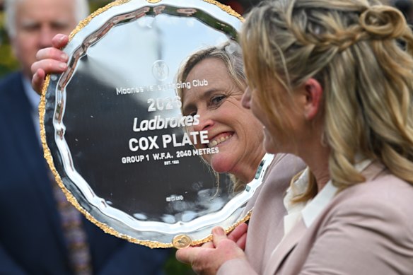 Trainer Andrea Leek poses with the trophy.