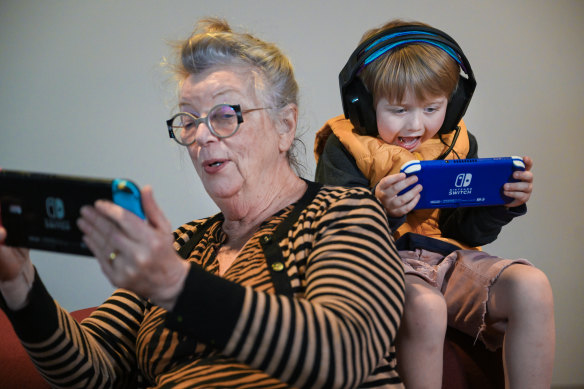 Roz Rogers, 76, and Noah Hanson, 5, play a Nintendo game together.